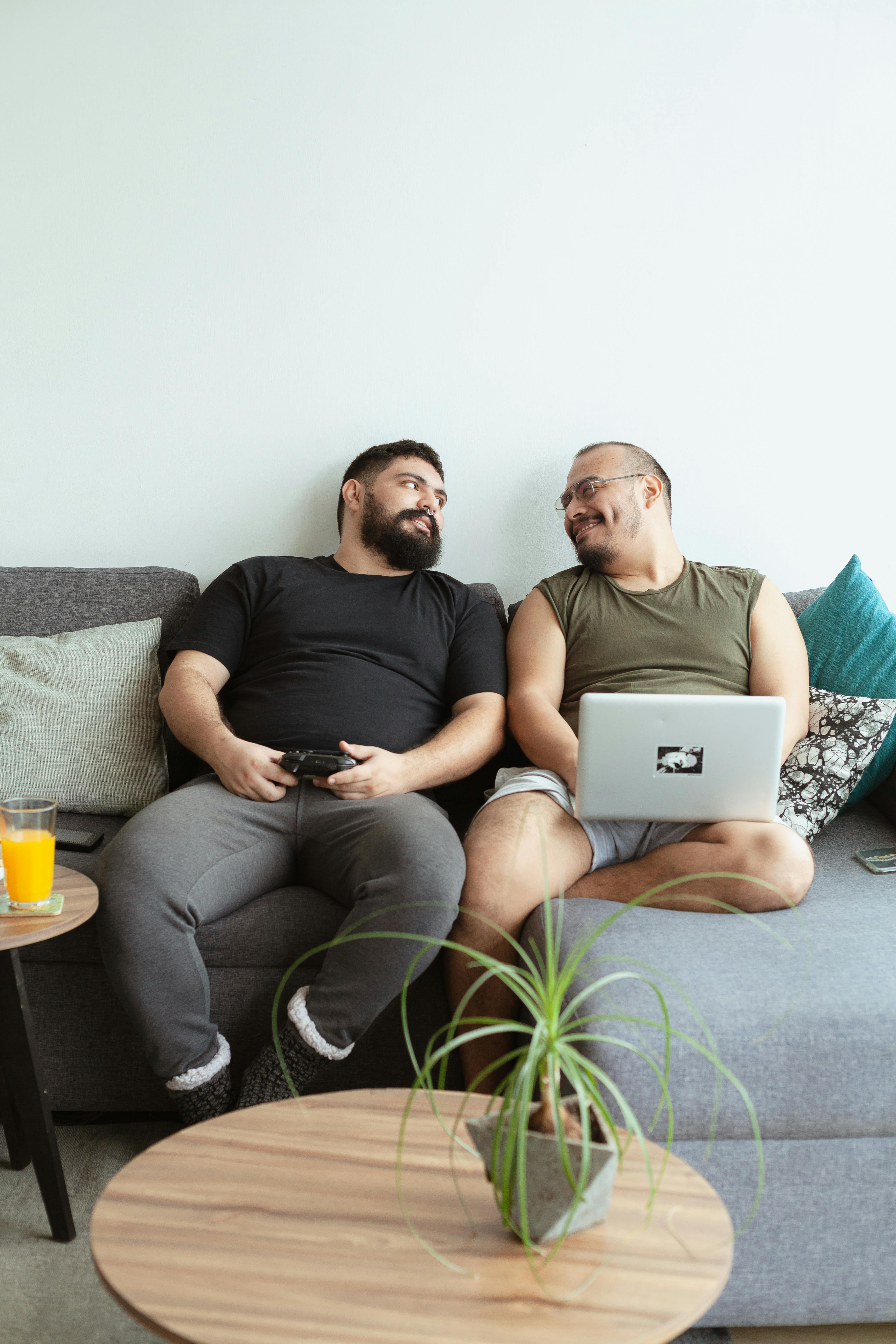Couples Counseling - KLS Collective Therapy Group two men on couch with computer in laps